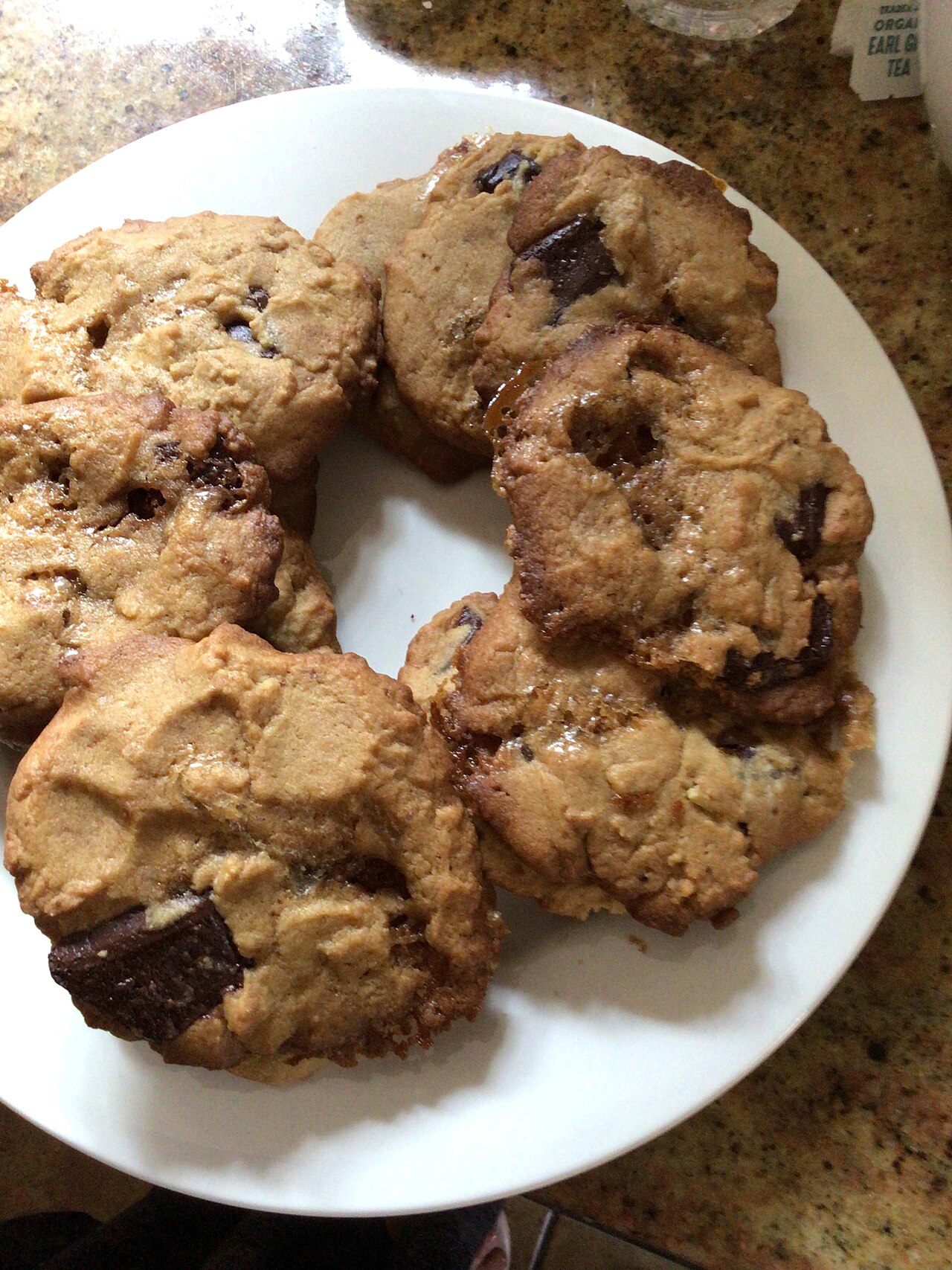 A plate piled with golden chocolate chip cookies