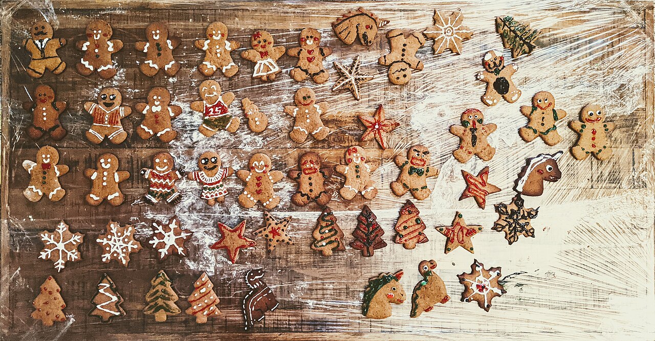 A large assortment of decorated gingerbread people, trees and stars