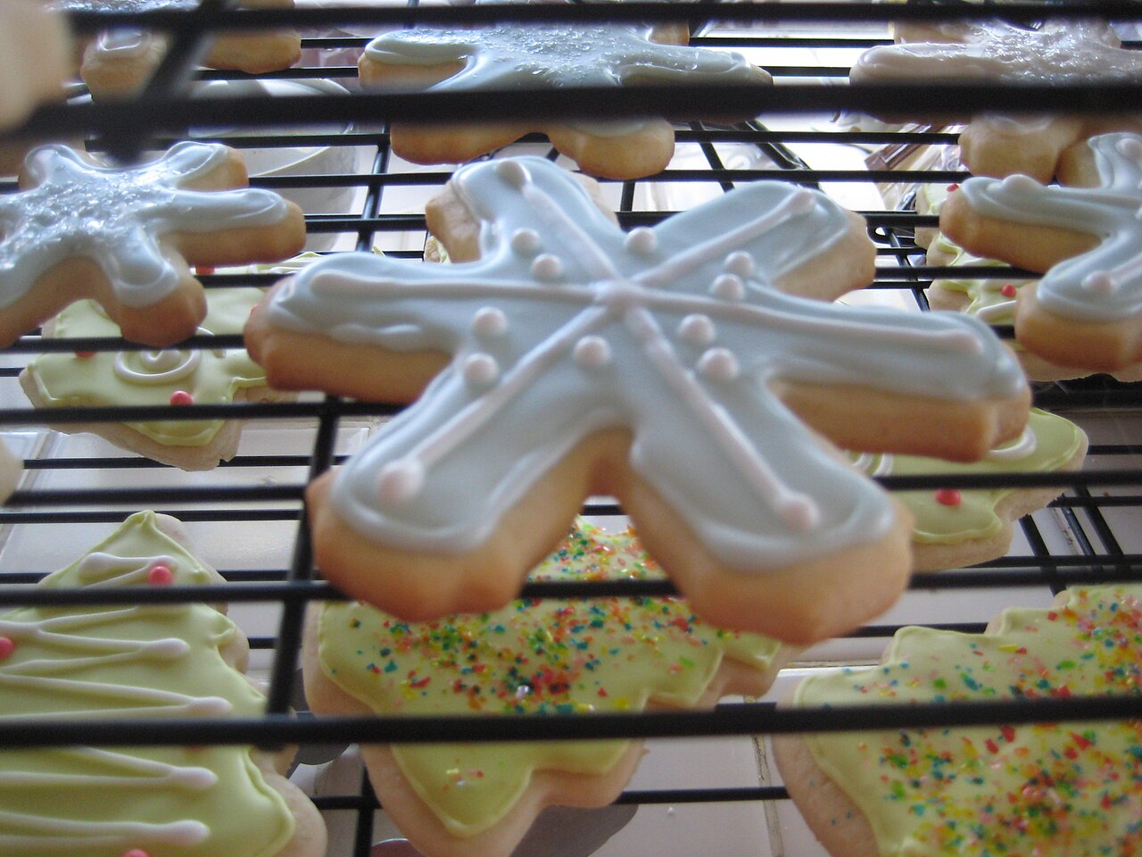 Snowflake and Christmas tree sugar cookies decorated with royal icing